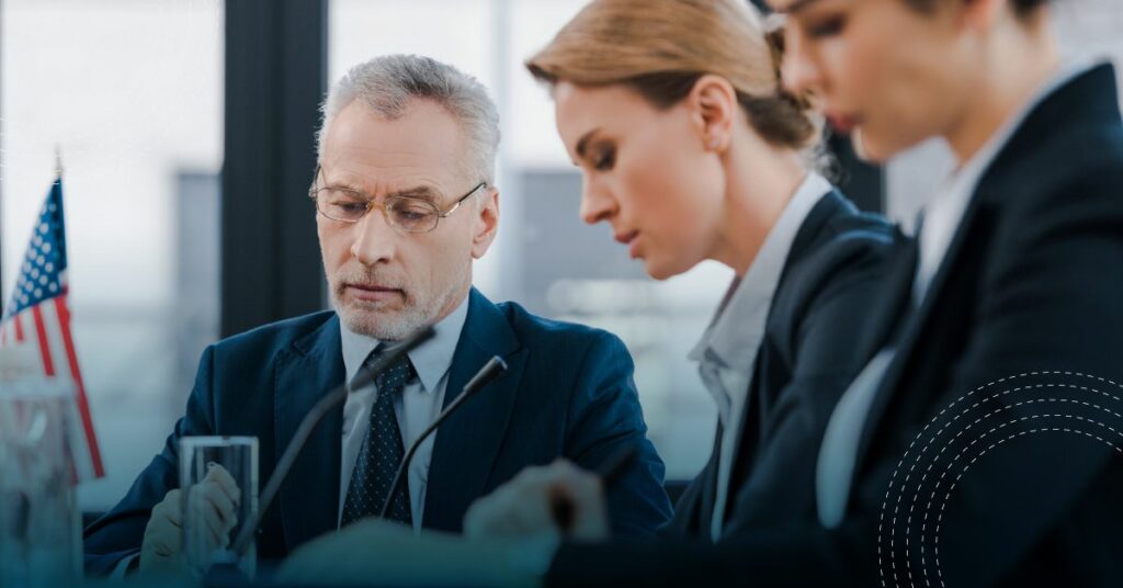 Interpreter skills being used in conference by three people at a table